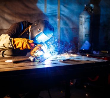 Worker cutting metal with plasma equipment. on plant